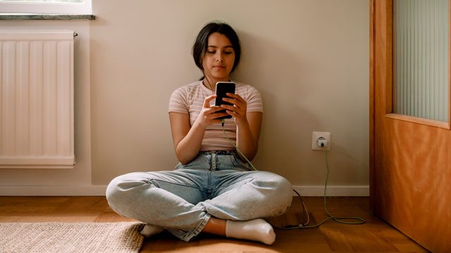 Teenagers looking at their phones and texting